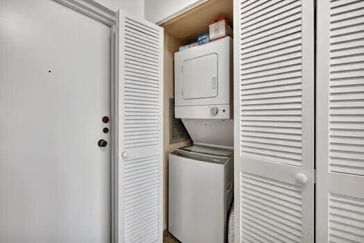 111 N N Pompano Beach Blvd Unit 411, Pompano Beach, FL 33062 - washroom featuring stacked washer and clothes dryer