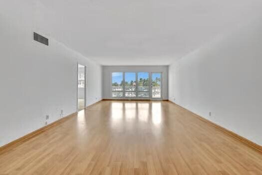 111 N N Pompano Beach Blvd Unit 411, Pompano Beach, FL 33062 - empty room with wood finished floors and baseboards