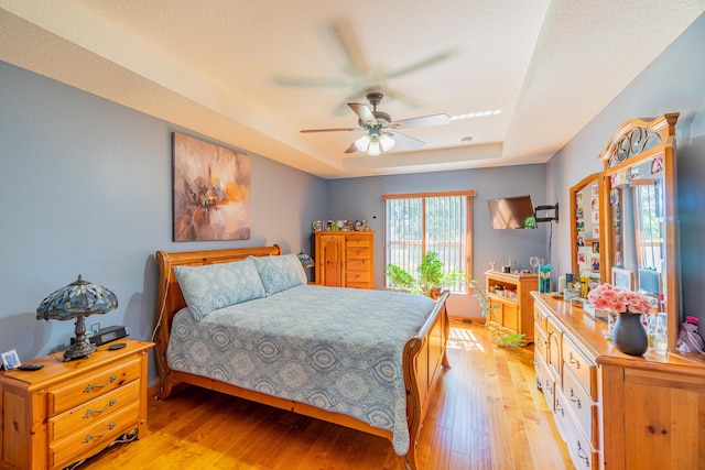 3542 SW Rosardo St, Port Saint Lucie, FL 34953 - bedroom with a raised ceiling, light wood-type flooring, and a ceiling fan