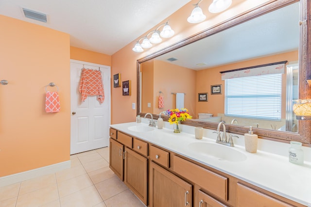 3542 SW Rosardo St, Port Saint Lucie, FL 34953 - bathroom with double vanity, tile patterned floors, and baseboards
