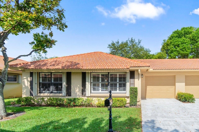 4680 Rosewood Tree Ct Unit A, Boynton Beach, FL 33436 - ranch-style house featuring stucco siding, a garage, a tiled roof, concrete driveway, and a front lawn