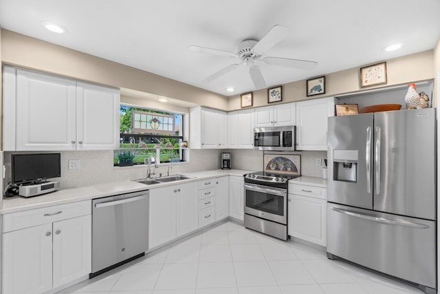 4680 Rosewood Tree Ct Unit A, Boynton Beach, FL 33436 - kitchen with stainless steel appliances, a sink, light countertops, ceiling fan, and white cabinetry