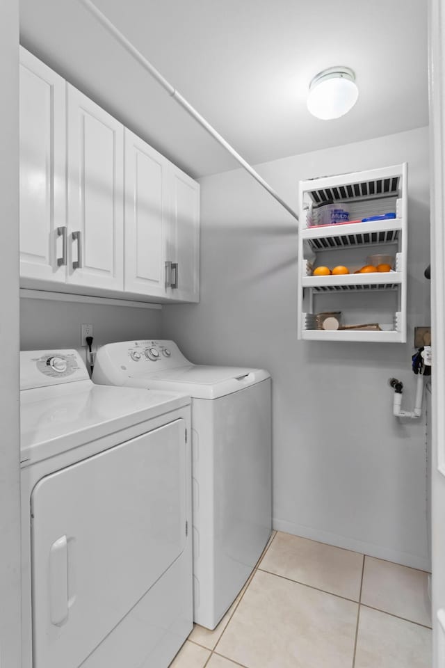 437 Pine Glen Ln Unit B-2, Greenacres, FL 33463 - laundry area featuring cabinet space, washing machine and clothes dryer, and light tile patterned floors