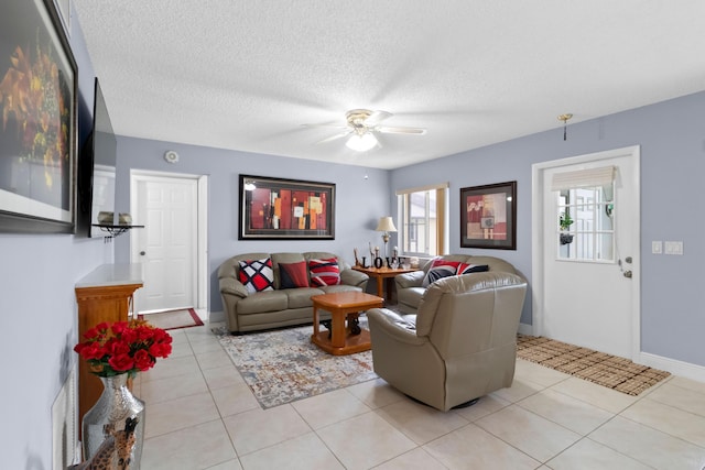 437 Pine Glen Ln Unit B-2, Greenacres, FL 33463 - living area featuring a ceiling fan, light tile patterned floors, a textured ceiling, and baseboards