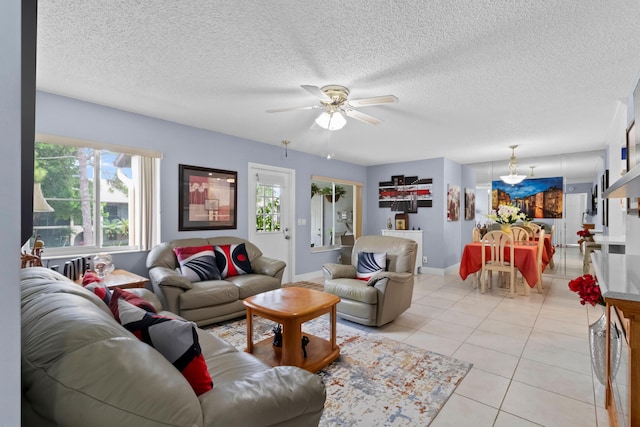 437 Pine Glen Ln Unit B-2, Greenacres, FL 33463 - living room with light tile patterned floors, ceiling fan, baseboards, and a textured ceiling