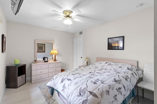 437 Pine Glen Ln Unit B-2, Greenacres, FL 33463 - bedroom featuring light wood-style floors, a textured ceiling, and ceiling fan