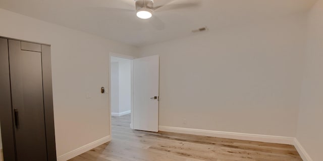 126 NW 3rd Ct, Boca Raton, FL 33432 - empty room with a ceiling fan, light wood finished floors, and baseboards