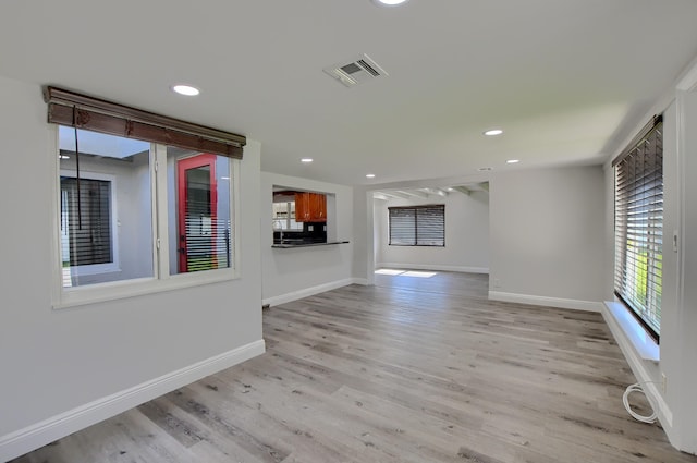 126 NW 3rd Ct, Boca Raton, FL 33432 - unfurnished living room featuring light wood finished floors, baseboards, and recessed lighting