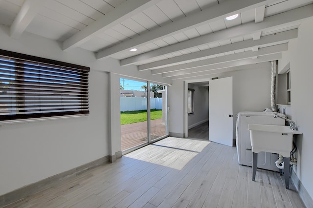 126 NW 3rd Ct, Boca Raton, FL 33432 - laundry area with light wood-style floors, washing machine and dryer, baseboards, and wooden ceiling