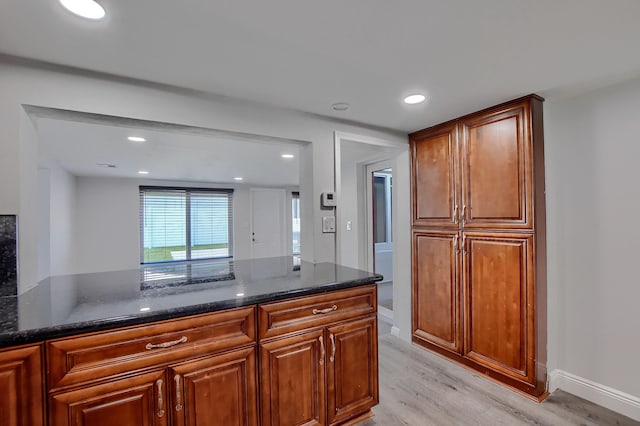 126 NW 3rd Ct, Boca Raton, FL 33432 - kitchen with light wood finished floors, dark stone countertops, recessed lighting, and brown cabinetry