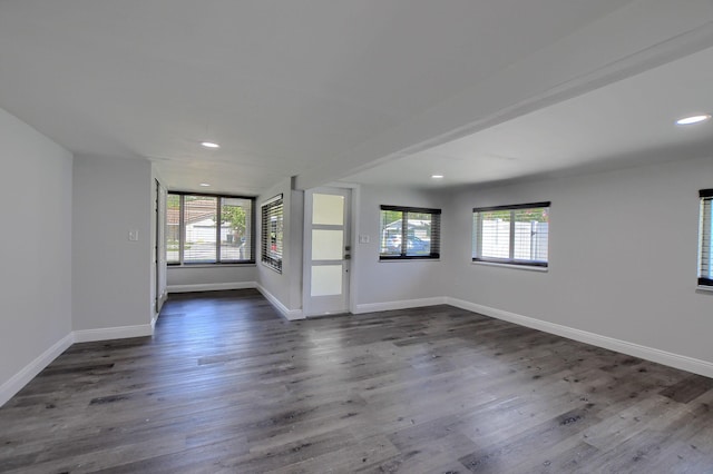 126 NW 3rd Ct, Boca Raton, FL 33432 - unfurnished living room with plenty of natural light, recessed lighting, dark wood-style flooring, and baseboards