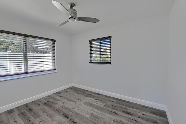 126 NW 3rd Ct, Boca Raton, FL 33432 - spare room with wood finished floors, baseboards, and a ceiling fan