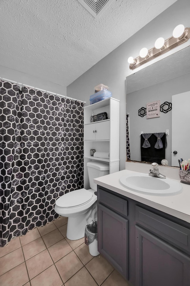 1352 SW Halford Ave, Port Saint Lucie, FL 34953 - full bath featuring vanity, toilet, tile patterned flooring, a textured ceiling, and a shower with shower curtain