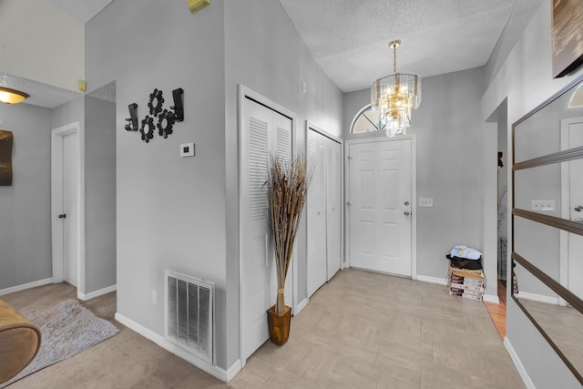 1352 SW Halford Ave, Port Saint Lucie, FL 34953 - entrance foyer with a chandelier, baseboards, and a textured ceiling