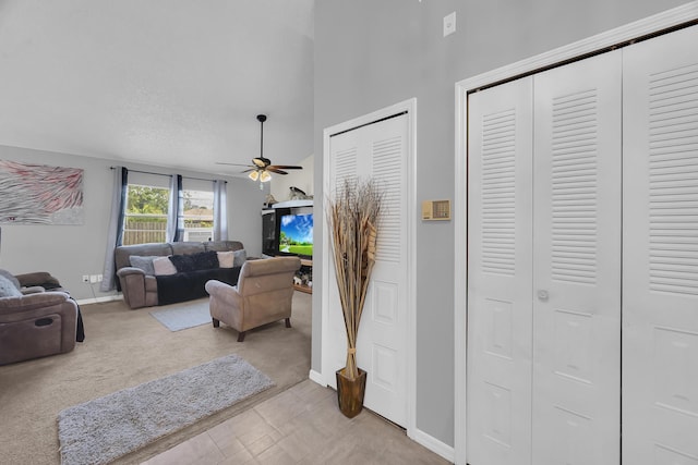 1352 SW Halford Ave, Port Saint Lucie, FL 34953 - living room featuring baseboards, a ceiling fan, light carpet, and a towering ceiling