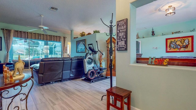 2608 SW River Shore Dr, Port Saint Lucie, FL 34984 - living room with a ceiling fan, a textured ceiling, and wood finished floors