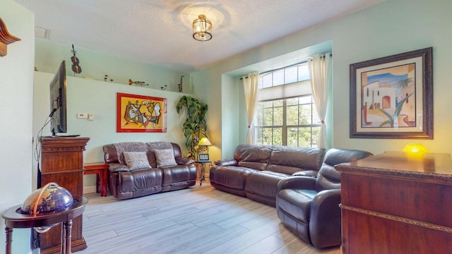 2608 SW River Shore Dr, Port Saint Lucie, FL 34984 - living area featuring a textured ceiling and light wood-style floors
