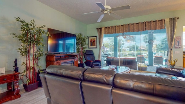 2608 SW River Shore Dr, Port Saint Lucie, FL 34984 - living area with wood finished floors, ceiling fan, and a textured ceiling