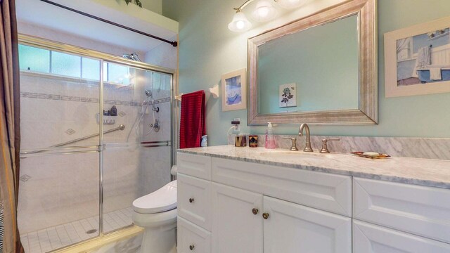 2608 SW River Shore Dr, Port Saint Lucie, FL 34984 - full bathroom featuring toilet, vanity, and a shower stall