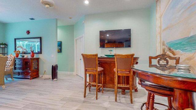 2608 SW River Shore Dr, Port Saint Lucie, FL 34984 - dining area with baseboards, recessed lighting, wood finished floors, and a dry bar