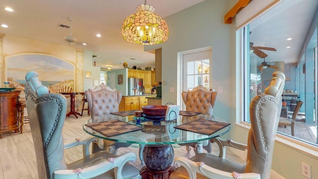 2608 SW River Shore Dr, Port Saint Lucie, FL 34984 - dining space with healthy amount of natural light, recessed lighting, baseboards, light wood-style floors, and a chandelier