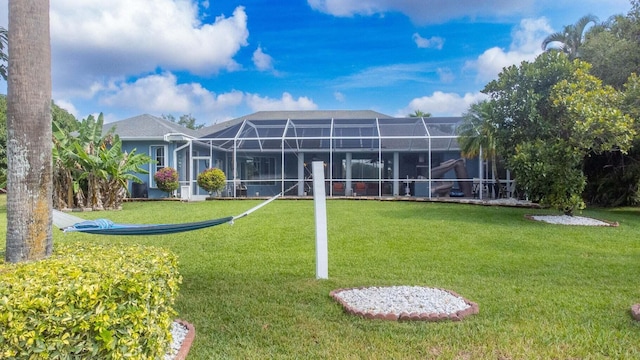 2608 SW River Shore Dr, Port Saint Lucie, FL 34984 - rear view of house with a lawn and glass enclosure