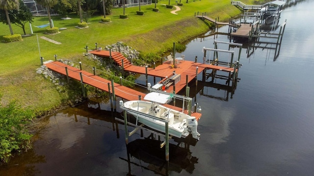 2608 SW River Shore Dr, Port Saint Lucie, FL 34984 - dock area featuring boat lift, a water view, and a lawn