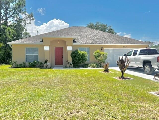 8065 99th Ct, Vero Beach, FL 32967 - view of front of property featuring a garage, stucco siding, a front yard, and driveway
