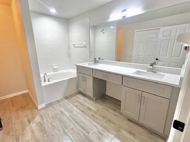 8065 99th Ct, Vero Beach, FL 32967 - bathroom with double vanity, wood tiled floors, tiled shower / bath, and recessed lighting