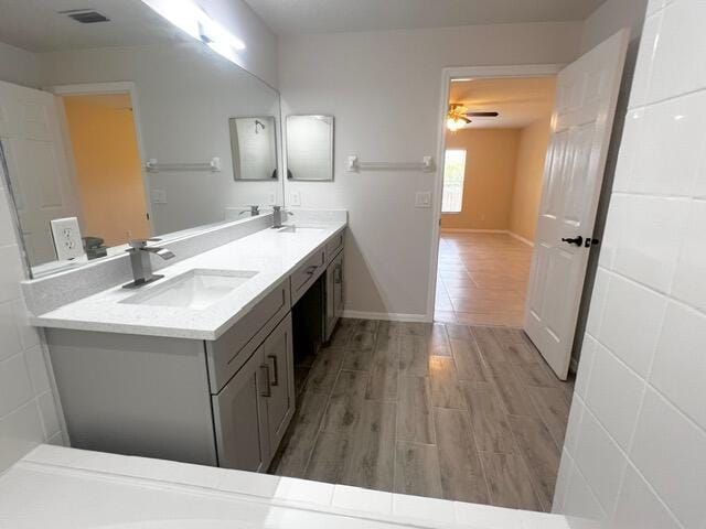 8065 99th Ct, Vero Beach, FL 32967 - full bath with double vanity, wood finished floors, and ceiling fan