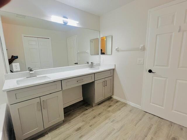 8065 99th Ct, Vero Beach, FL 32967 - full bathroom with double vanity and wood finished floors