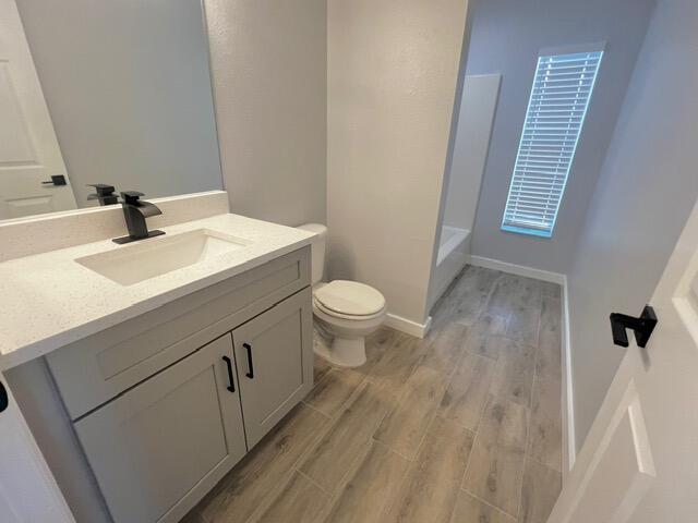 8065 99th Ct, Vero Beach, FL 32967 - bathroom featuring wood finished floors, vanity, a bathtub, and a shower
