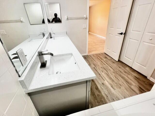 8065 99th Ct, Vero Beach, FL 32967 - full bath with double vanity and wood finished floors