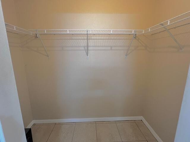 8065 99th Ct, Vero Beach, FL 32967 - spacious closet featuring tile patterned floors