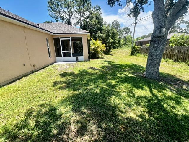 8065 99th Ct, Vero Beach, FL 32967 - view of yard featuring a sunroom