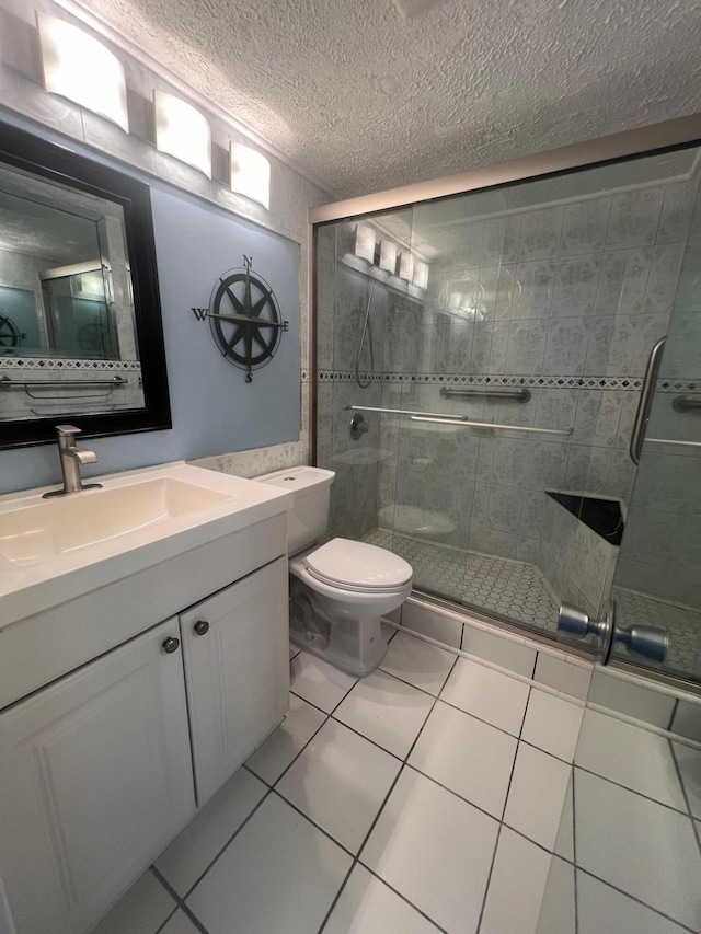 161 Dorset D, Boca Raton, FL 33434 - bathroom featuring vanity, a shower stall, toilet, a textured ceiling, and tile patterned flooring