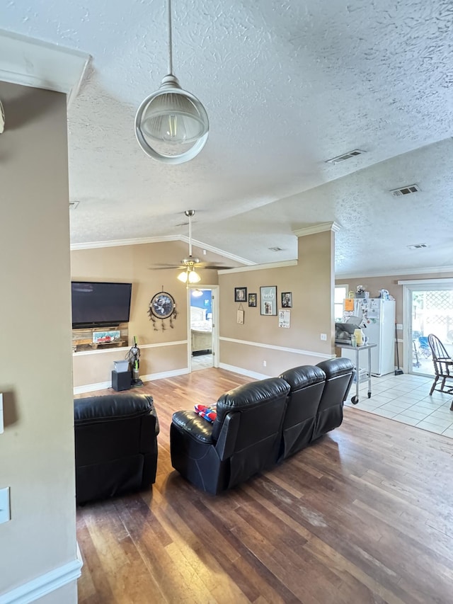 7810 Santa Clara Blvd, Fort Pierce, FL 34951 - living room featuring wood finished floors, a ceiling fan, a textured ceiling, baseboards, and lofted ceiling