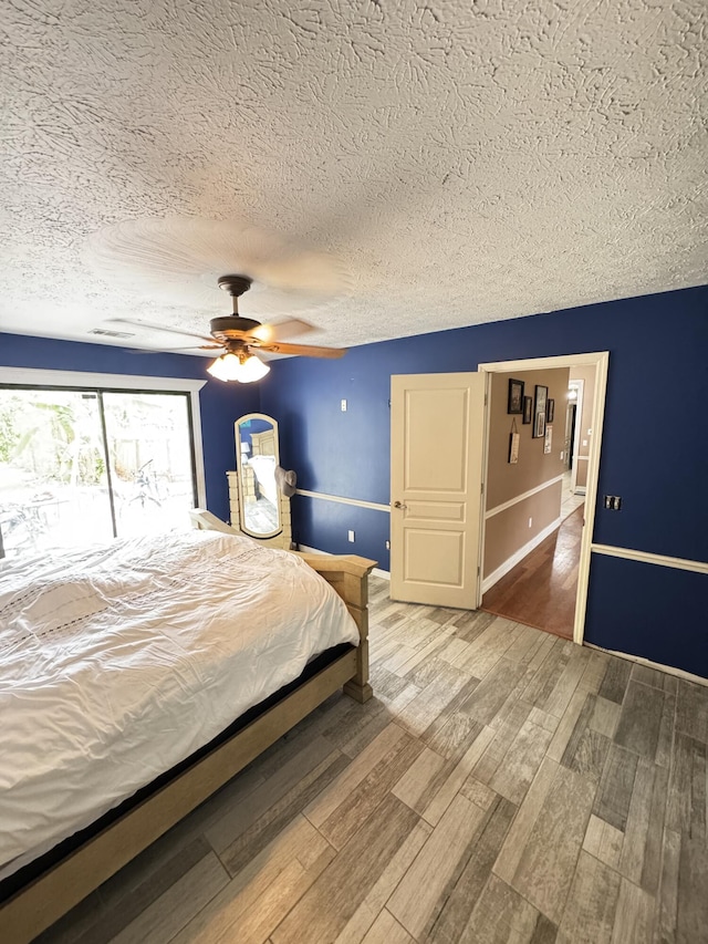 7810 Santa Clara Blvd, Fort Pierce, FL 34951 - bedroom featuring wood finished floors, a textured ceiling, ceiling fan, and baseboards