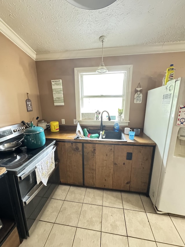 7810 Santa Clara Blvd, Fort Pierce, FL 34951 - kitchen featuring white refrigerator with ice dispenser, double oven range, a sink, crown molding, and a textured ceiling