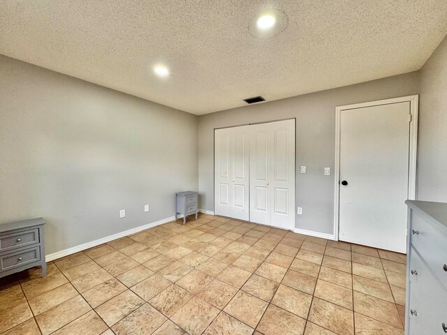 15015 SW 49th Ln Unit A-113, Miami, FL 33185 - unfurnished bedroom featuring a textured ceiling, a closet, and baseboards