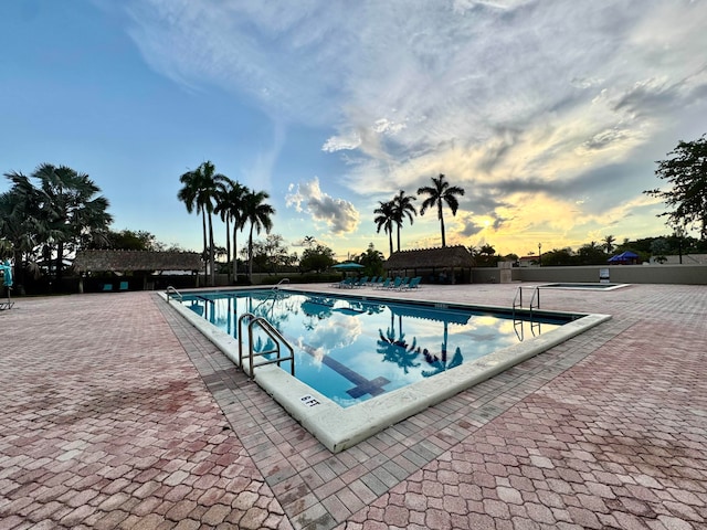 15015 SW 49th Ln Unit A-113, Miami, FL 33185 - pool at dusk with a community pool and a patio