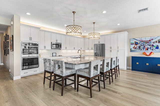 9657 Sterling Shores St, Delray Beach, FL 33446 - dining area with light wood-style floors, recessed lighting, baseboards, a textured ceiling, and a chandelier