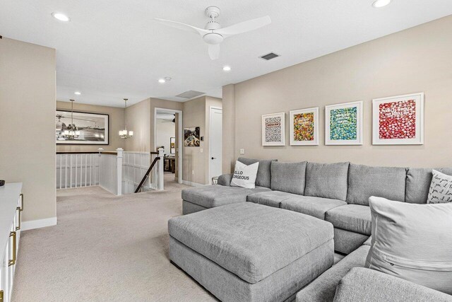 9657 Sterling Shores St, Delray Beach, FL 33446 - carpeted living room featuring recessed lighting, baseboards, ceiling fan, and a chandelier