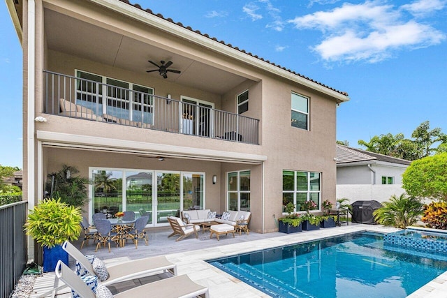 9657 Sterling Shores St, Delray Beach, FL 33446 - rear view of property featuring a balcony, outdoor lounge area, stucco siding, ceiling fan, and a pool with connected hot tub