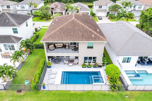 9657 Sterling Shores St, Delray Beach, FL 33446 - rear view of house with a balcony, a pool with connected hot tub, a residential view, and a fenced backyard
