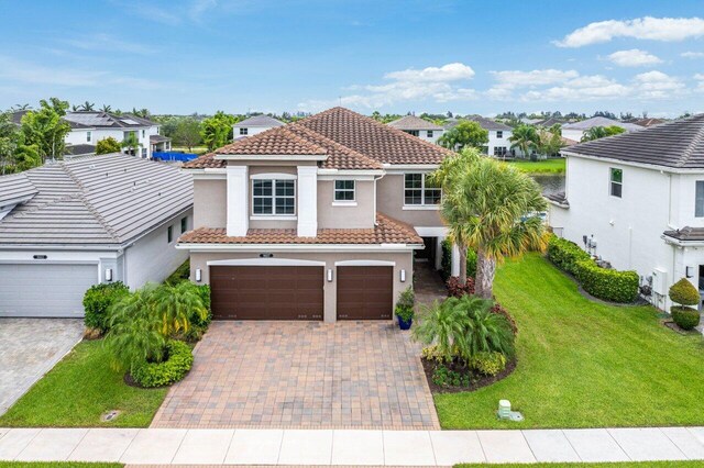 9657 Sterling Shores St, Delray Beach, FL 33446 - view of front of property featuring a tile roof, stucco siding, an attached garage, decorative driveway, and a residential view