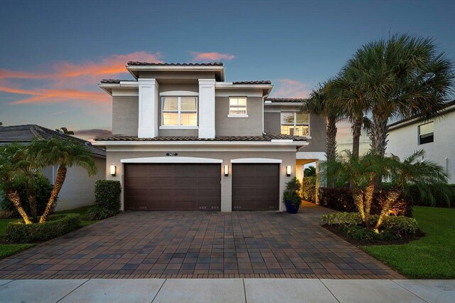 9657 Sterling Shores St, Delray Beach, FL 33446 - mediterranean / spanish home with a garage, decorative driveway, stucco siding, and a tiled roof