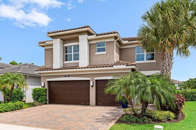 9657 Sterling Shores St, Delray Beach, FL 33446 - view of front of house featuring a garage, stucco siding, decorative driveway, and a tiled roof