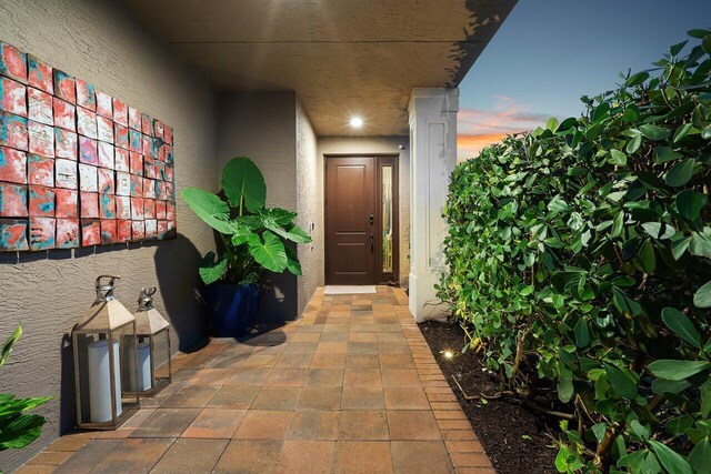 9657 Sterling Shores St, Delray Beach, FL 33446 - exterior entry at dusk featuring stucco siding