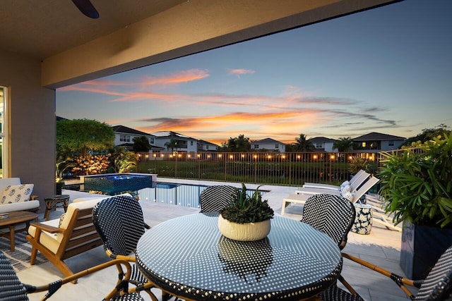 9657 Sterling Shores St, Delray Beach, FL 33446 - patio terrace at dusk featuring outdoor dining area, a fenced backyard, and a patio